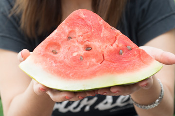 Woman holding watermelon slice
