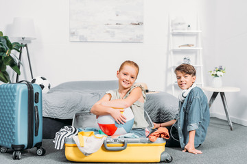 kids packing clothes for trip