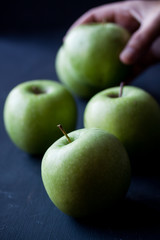 Green apples on a black background
