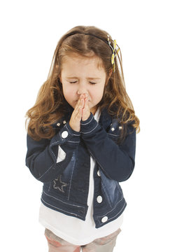 Little girl praying - closeup. Isolated on white background