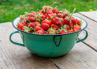Ripe red strawberries in bowl on wooden table. Fresh juice strawberry, healthy organic berry food