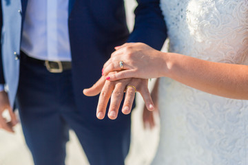 Honeymoon couple holding hands at beach wedding