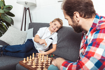 father and son playing chess