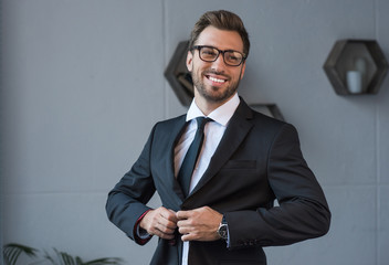 businessman putting on blazer