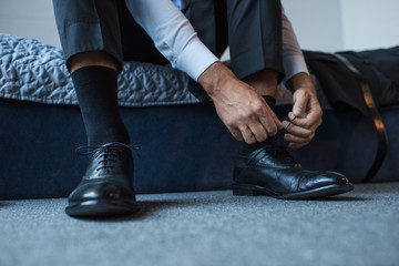 Fototapeta premium Man tying shoelaces