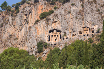 Fototapeta na wymiar Rocky shores of the river Dalyan in Turkey with ancient Lycian tombs, selective focus