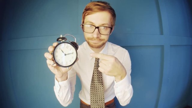 A nerdy guy with alarm clock. No time concept