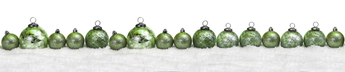 Green christmas balls in the snow