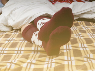 Photo Woman Sofa Bed Rest Plaid Soft Toned Lifestyle, feet with socks, brown plaid