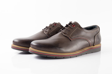 Male brown leather shoe on white background, isolated product, comfortable footwear.