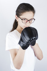 A teenager in sports uniform and glasses is boxing. Protection concept