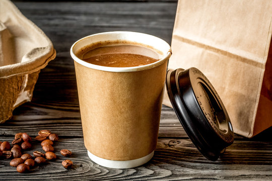 coffee cup to go at wooden background