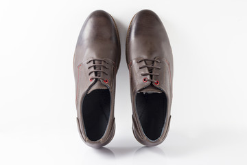 Male brown leather shoe on white background, isolated product.