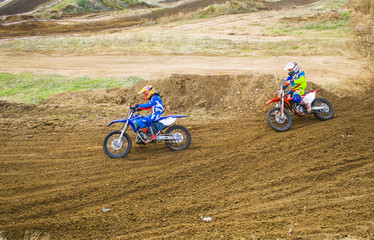 Extreme sport. Two sportsmen on a motorcycle turn on a turn.