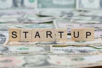 the word "START UP" written in wooden block letters