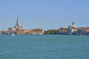 Fototapeta na wymiar A view of the island of Giudecca in Venice taken from the island of Giudecca. The church of San Giorgio Maggiore can be seen on left, and Zitelle on the right