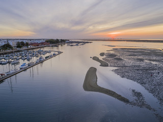 Sunrise aerial seascape view of Olhao Marina, waterfront to Ria Formosa natural park. Algarve.