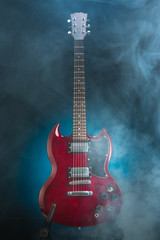 electric guitar in smoke, blue background