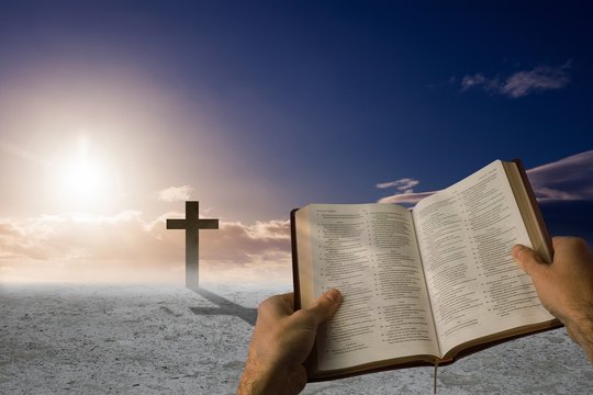 Composite image of man holding a holy bible