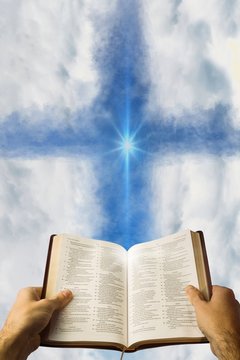 Composite image of man holding a holy bible