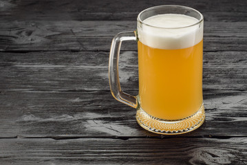 Beer mug on a dark wooden table