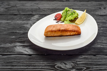 Grilled Fish Fillet over dark wooden background
