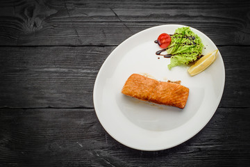 Grilled Fish Fillet over dark wooden background