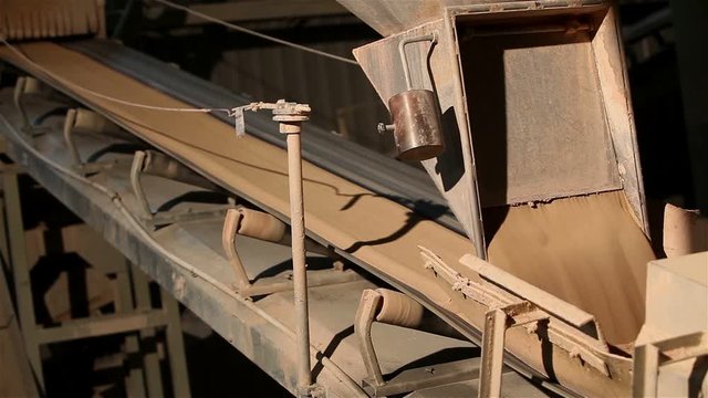 Сonveyor belt on factory, Ceramic factory equipment, Transportation of clay on the conveyor, industrial interior, Transportation of raw materials on the conveyor
