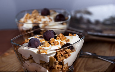 Yogur, Granola, Miel y Uvas cosechadas en casa servi9das en un cuenco de cristal
