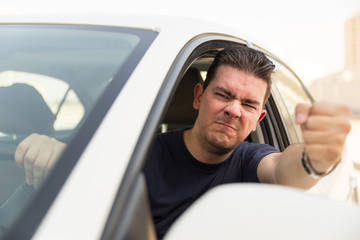 Angry driver pissed off by drivers in front of him and gesturing with hands. Road rage traffic jam...