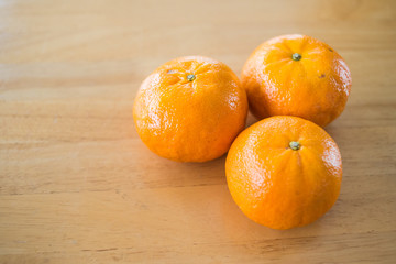 orange fruits on the wood table, Healthy fruits concept.