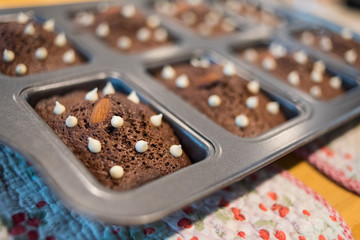 Brownie chocolate cake  with nut on hot tray plate on the wood table.
