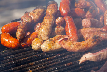 Cooking fresh Sausages on grill.