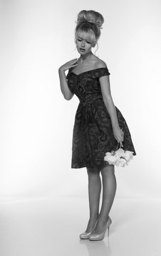 portrait of a beautiful blonde woman in retro dress 50-s style . monochrome black and white photo