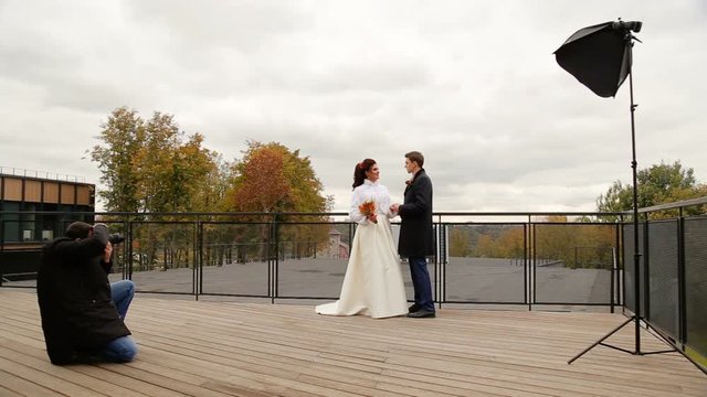 Photographer taking pictures couple of newlyweds