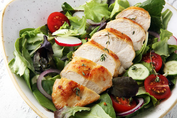 Chicken salad with leaf vegetables and cherry tomatoes.
