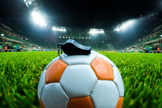 Football Ball With Whistle On The Grass On Soccer Stadium