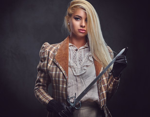 An attractive blonde female holds a silver sword.