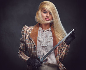 An attractive blonde female holds a silver sword.