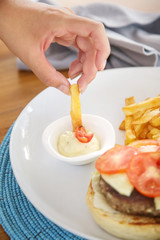 Hamburger and fries served on the restaurant table