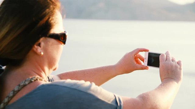 woman is making a photo on the phone