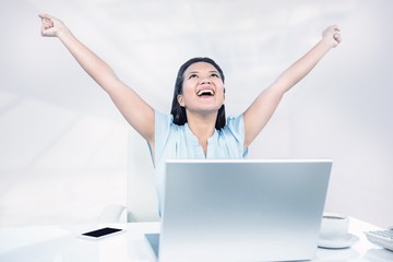 Composite image of celebrating woman with arms raised