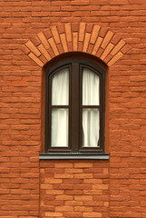 Fototapeta na wymiar wall of an old red brick building with a window