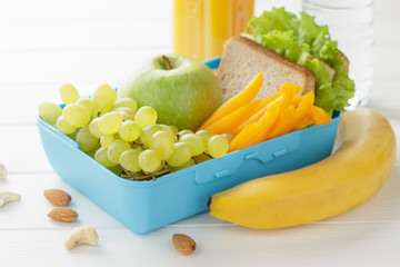 Concept of healthy food for school or work on white wooden background.