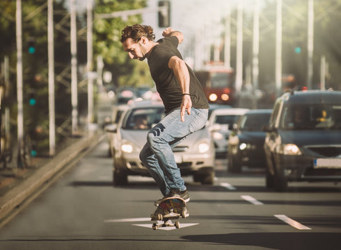 Pro skater doing tricks and jumps on street. Free ride