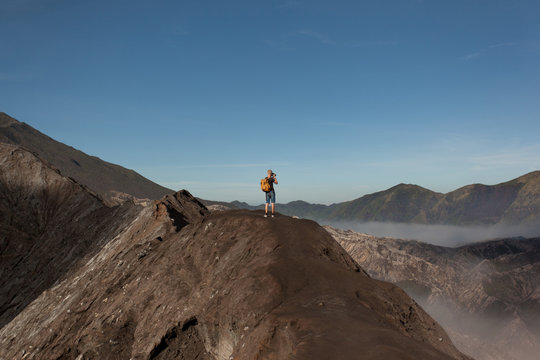 Man standing at Rim of Mount Bromo