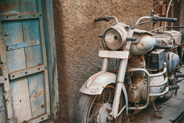Rusty and dirty motorbike parked on the street