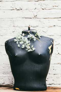Vintage female torso decorated with summer flowers