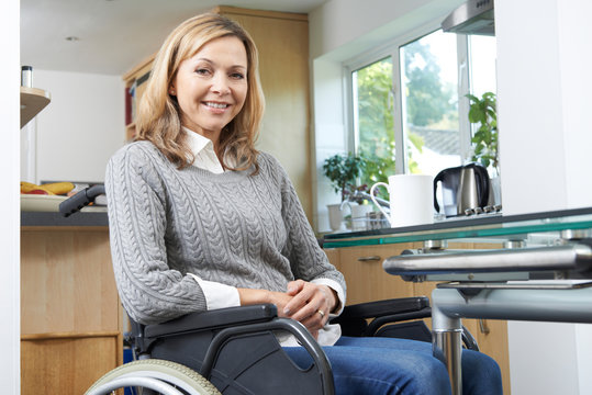 Portrait Of Mature Disabled Woman In Wheelchair At Home