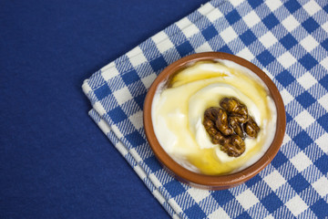 greek yogurt with honey and walnut in a bowl